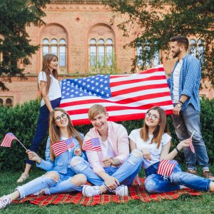 Students in the University This is Independence Day! A group of students of US-flag patriots standing in the background at a campus. Rejoice at the great feast